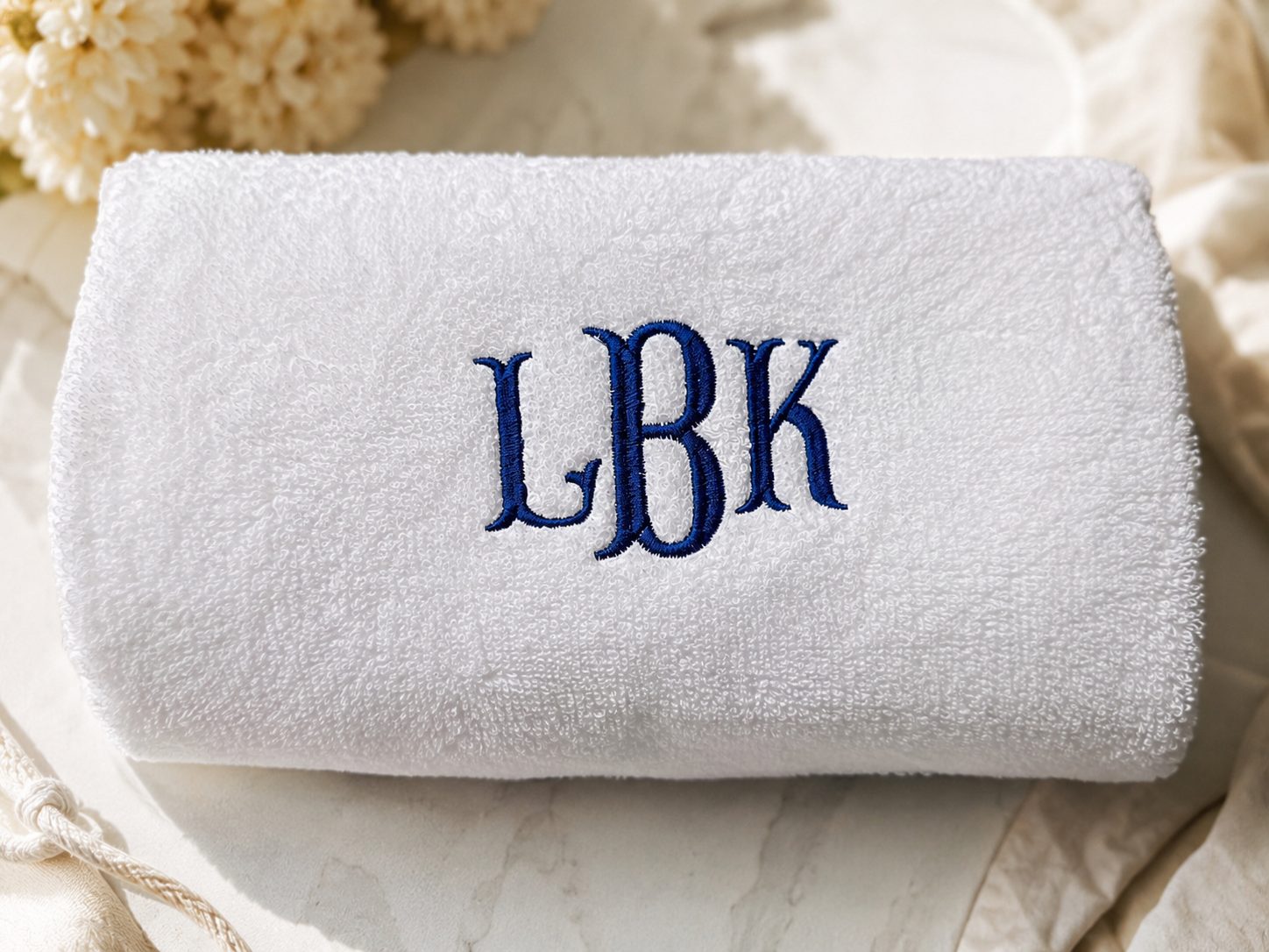 Rolled towel with custom monogram embroidery